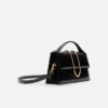 Den stora Bambino Cross-body-väskan med metallklaff Den stora Bambino Cross-body-väskan med metallklaff