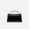 Den stora Bambino Cross-body-väskan med metallklaff Den stora Bambino Cross-body-väskan med metallklaff