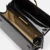 Den stora Bambino Cross-body-väskan med metallklaff Den stora Bambino Cross-body-väskan med metallklaff